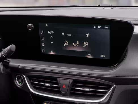 Car dashboard displaying a digital climate control screen. The temperature is set to 68°F, with icons for airflow direction, fan speed, and air conditioning. The interface is sleek, set against a dark interior.