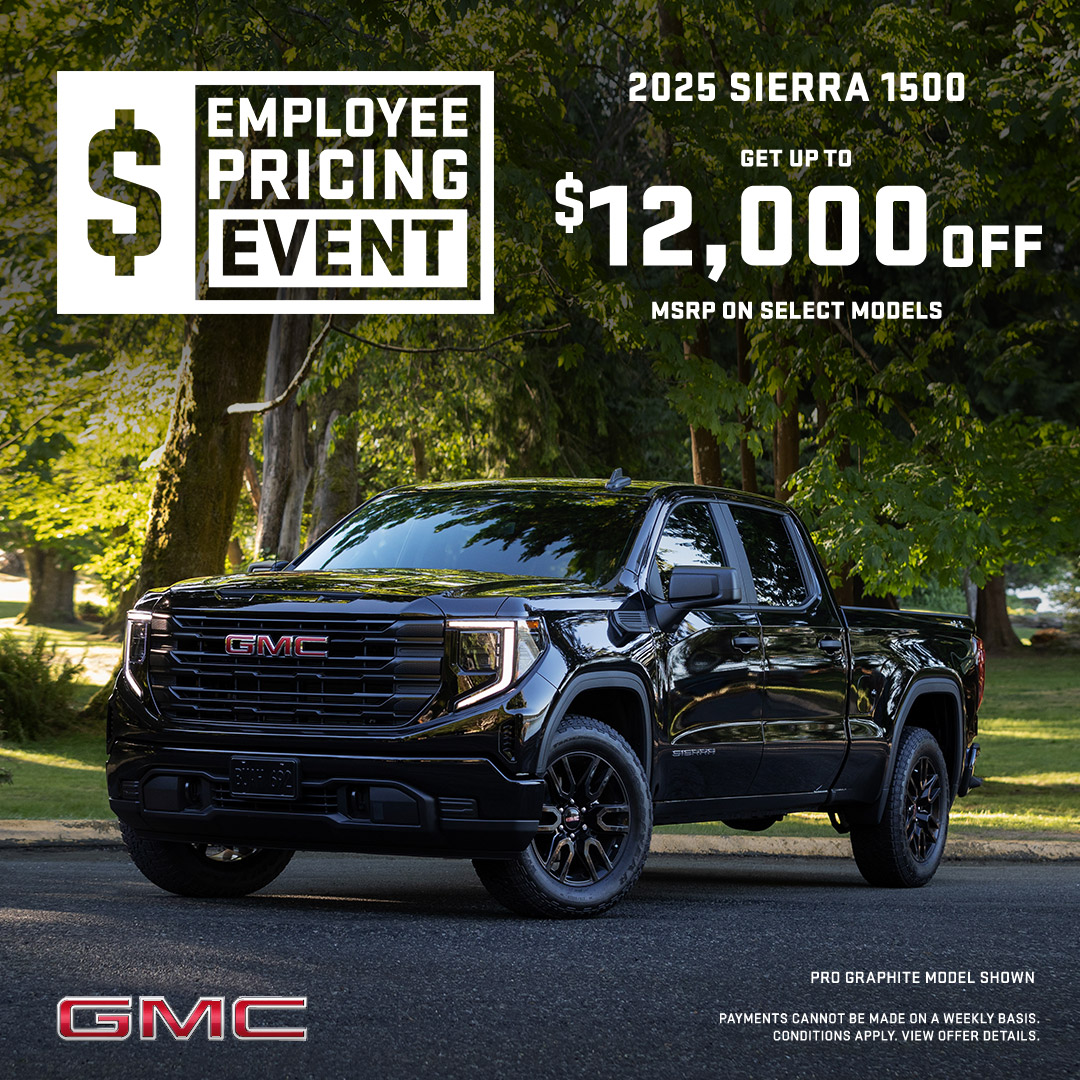 GMC 2025 Sierra 1500 parked in a forest setting. Employee pricing event offers up to $12,000 off select models.