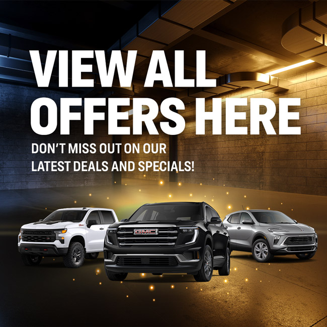Cars showcased in a dimly lit garage with text promoting offers and deals.