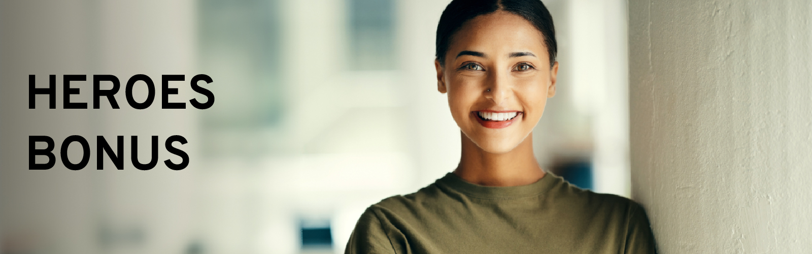 Smiling woman next to text "HEROES BONUS" on a blurred background.