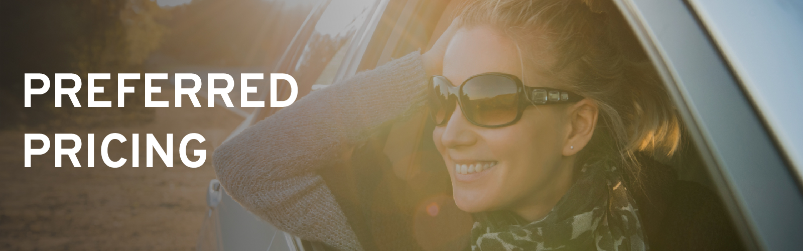 Woman in sunglasses smiling leaned out car window, with "Preferred Pricing" text overlay.